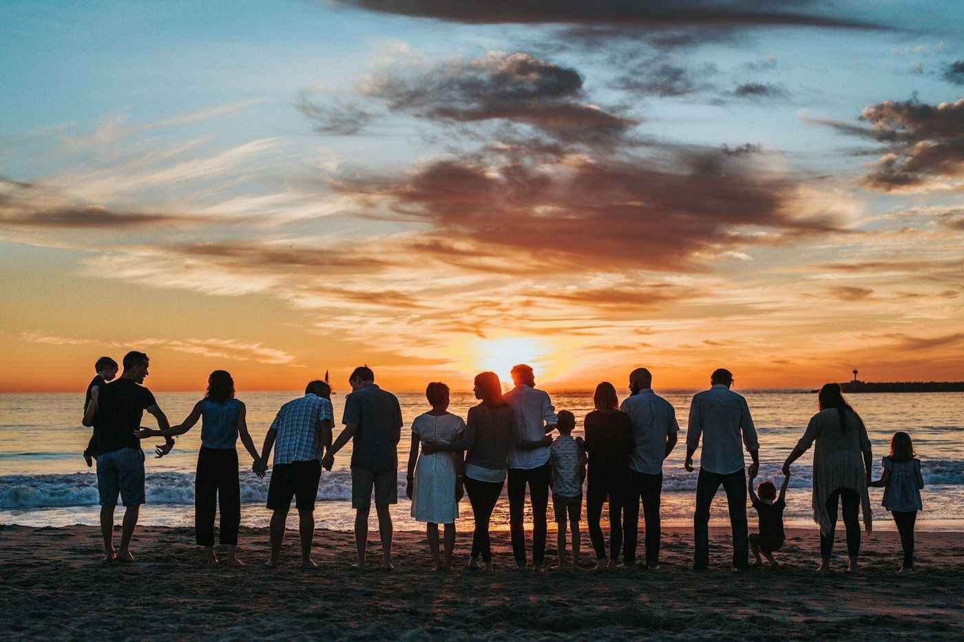 A family silhouetted against a sunset, the clients immigration attorney marketing is meant to reach